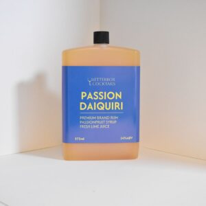 Handcrafted Passion Daiquiri cocktail in a 275ml bottle, gift-wrapped with fresh garnishes, ready to drink