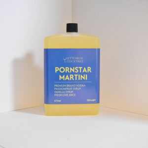Handcrafted Pornstar Martini cocktail in a 275ml bottle, gift-wrapped with fresh garnishes, ready to drink