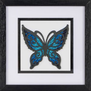 A paper quilled butterfly with a blue ombre